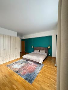 a bedroom with a bed and a rug on the floor at Spacious Family Apartment by the Sea in Jūrmala