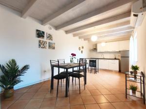 a kitchen and dining room with a table and chairs at Bellavista Iseo in Villongo SantʼAlessandro