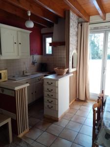 a kitchen with white cabinets and a counter top at Le Pas de l'Âne - Les Apparts du Sancy in Chastreix +3 photos