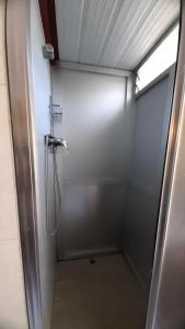 a shower stall with a shower head in a bathroom at Nido Ría in Villaviciosa +28 photos