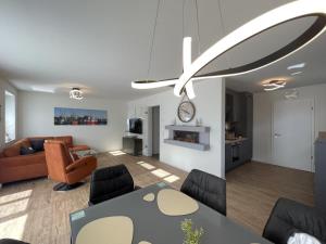 ein Wohnzimmer mit einem Sofa und einem Esstisch in der Unterkunft Am Kutterhafen 8a - Wattenmeer-Oase in Fedderwardersiel