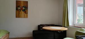 a table in a room with a chair and a picture at Rita's FeWo in Grossschönau