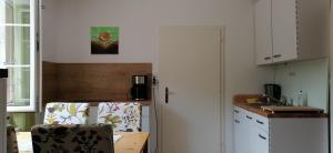 a kitchen with a table and a chair in a kitchen at Rita's FeWo in Grossschönau