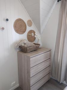 a room with a dresser and baskets on the wall at Light terrace city apartment Alesund in Ålesund +2 photos