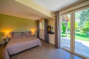 a bedroom with a bed and a sliding glass door at La Colline de Vence in Vence +23 photos