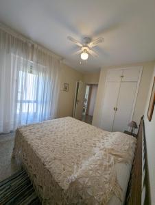 a bedroom with a bed and a ceiling fan at Apartamento en Calahonda, Urb Perla Andalucia in Calahonda +4 photos