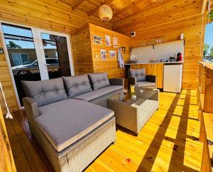 a living room with a couch and a table at CozyHut Бунгало под Наем in Chernomorets +20 photos
