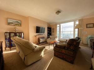a living room with two chairs and a television at Clifton Views in Folkestone