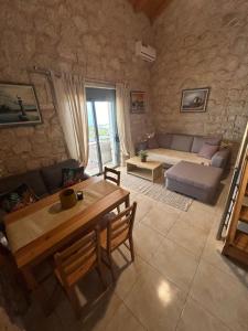 a living room with a table and a couch at Sun Castle Houses in Drymon