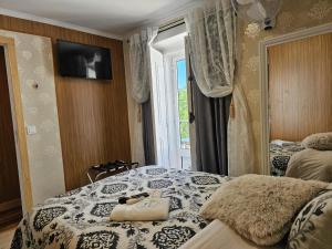a bedroom with two beds and a television on a wall at Charme da Graça - Guest House in Lisbon