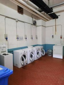 a laundry room with three washing machines in it at Casa StePa in Pescasseroli