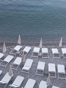 a group of chairs and umbrellas on a beach at Le Fontana in Nice