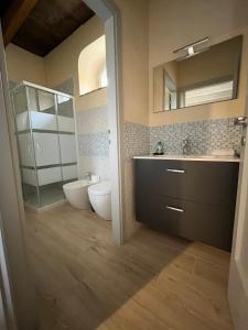a bathroom with a sink and a toilet and a mirror at Villino Giulio in Duddova +23 photos