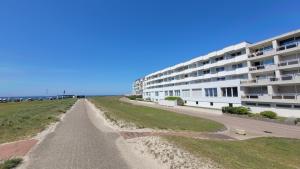 an empty road in front of a large building at Haus Seelord am Weststrand in Norderney
