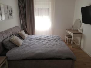 a bedroom with a bed and a desk and a window at Luxury Seaview Apartment with private pool in Kostrena +40 photos