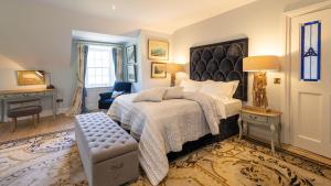 a bedroom with a large bed and a chair at Lissadell on The Beach in Lissadell +38 photos