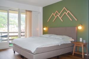 Postel nebo postele na pokoji v ubytování SWISSME - Neu-Seeblick-Balkon-Parkplatz-Nahe Bergbahn