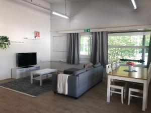 a living room with a couch and a table at Pohjoiskeskus 9 in Oulu +3 photos