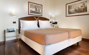 Postel nebo postele na pokoji v ubytování Atilius Hotel & Suites