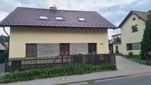 a house with a fence in front of it at Apartmán Malá Valaška in Ratiboř