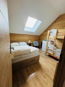 une chambre avec deux lits superposés et une lucarne dans l'établissement Chalet moderne tout confort à st lary village, à Saint-Lary-Soulan