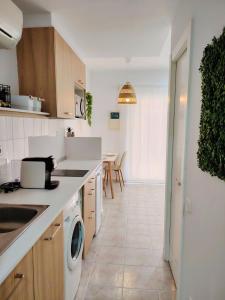 a kitchen with a washer and dryer in it at Apartamento junto a la playa en Lloret de mar in Lloret de Mar