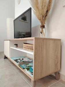 a tv cabinet with a television on top of it at Apartamento junto a la playa en Lloret de mar in Lloret de Mar
