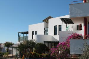 a row of white buildings with flowers in front of them at Casa San Miguel in San Miguel de Abona