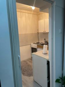 an open door to a kitchen with a stove at Urban Apartment in Sarajevo +4 photos