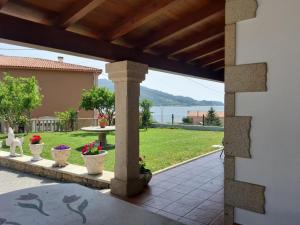 a view from the patio of a house with vases at Casa con vistas al mar in Noya +15 photos