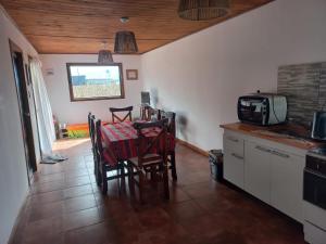 a kitchen with a table and chairs in a kitchen at Nuestro Rancho Chapadamalal in Colonia Chapadmalal
