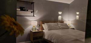 a bedroom with a bed and two night stands with lamps at Garden Lodge in Belfast