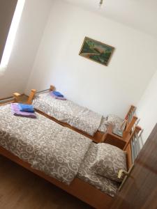 a bedroom with a bed and a picture on the wall at Vasko ROOMS in Ivanica
