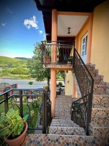 a staircase leading up to a house with a balcony at La Mateo in Călimăneşti