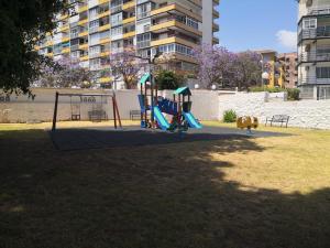 a playground in a park in a city at Blue Ocean Apartments in Benalmádena