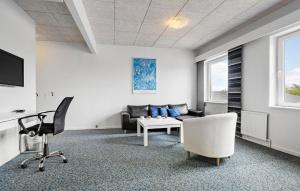 a living room with a couch and a chair at 11 Bedroom Gorgeous Home In Hurup Thy in Hurup