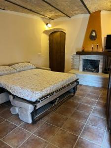 a bedroom with a bed and a fireplace at La casetta - Casa vacanze in Montenero Val Cocchiara
