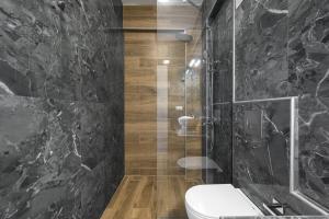 a bathroom with a toilet and a glass shower at Nikiti Summer Gem 1 by Luxlikehome in Nikiti +20 photos