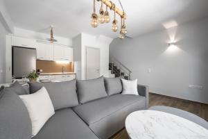 a living room with a gray couch and a kitchen at Nikiti Summer Gem 1 by Luxlikehome in Nikiti