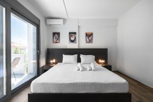 a bedroom with a white bed and a large window at Nikiti Summer Gem 1 by Luxlikehome in Nikiti