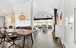 a dining room and living room with a table and chairs at Beautiful Home In Hejls With Wifi in Hejls