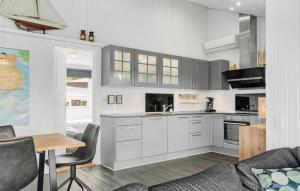 a kitchen with white cabinets and a table and a couch at Beautiful Home In Hejls With Wifi in Hejls