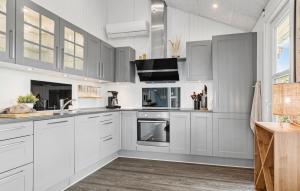 a kitchen with white cabinets and a sink at Beautiful Home In Hejls With Wifi in Hejls +11 photos