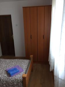 a bedroom with a bed and a dresser and curtains at Vasko ROOMS in Ivanica