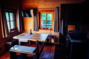 a wooden table in a cabin with a window at Ferienhaus am Teich in Kappel am Krappfeld