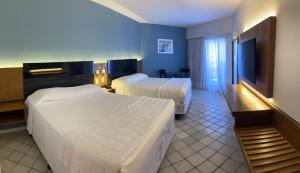 Cama ou camas em um quarto em HOTEL PIRÂMIDE NATAL