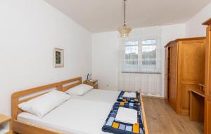 a bedroom with a bed and a window at Lovely Apartment In Omisalj With Wi-Fi in Omišalj