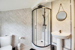 a bathroom with a shower and a toilet and a sink at Entire 3 bed house in Gloucester in Gloucester +13 photos