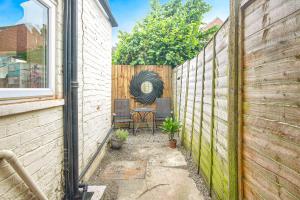 a patio with a table and chairs next to a fence at Entire 3 bed house in Gloucester in Gloucester