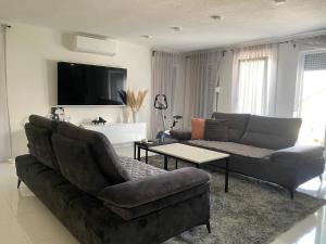 a living room with a couch and a tv at Villa La Familia in Bihać +13 photos
